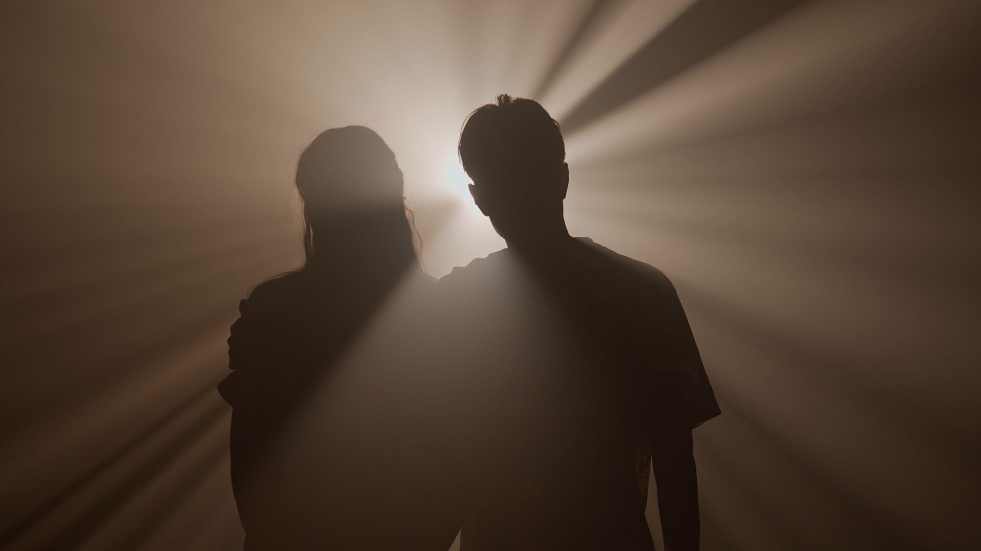 Silhouettes,Of,Man,And,Woman,Hugging,And,Walking,Towards,Camera